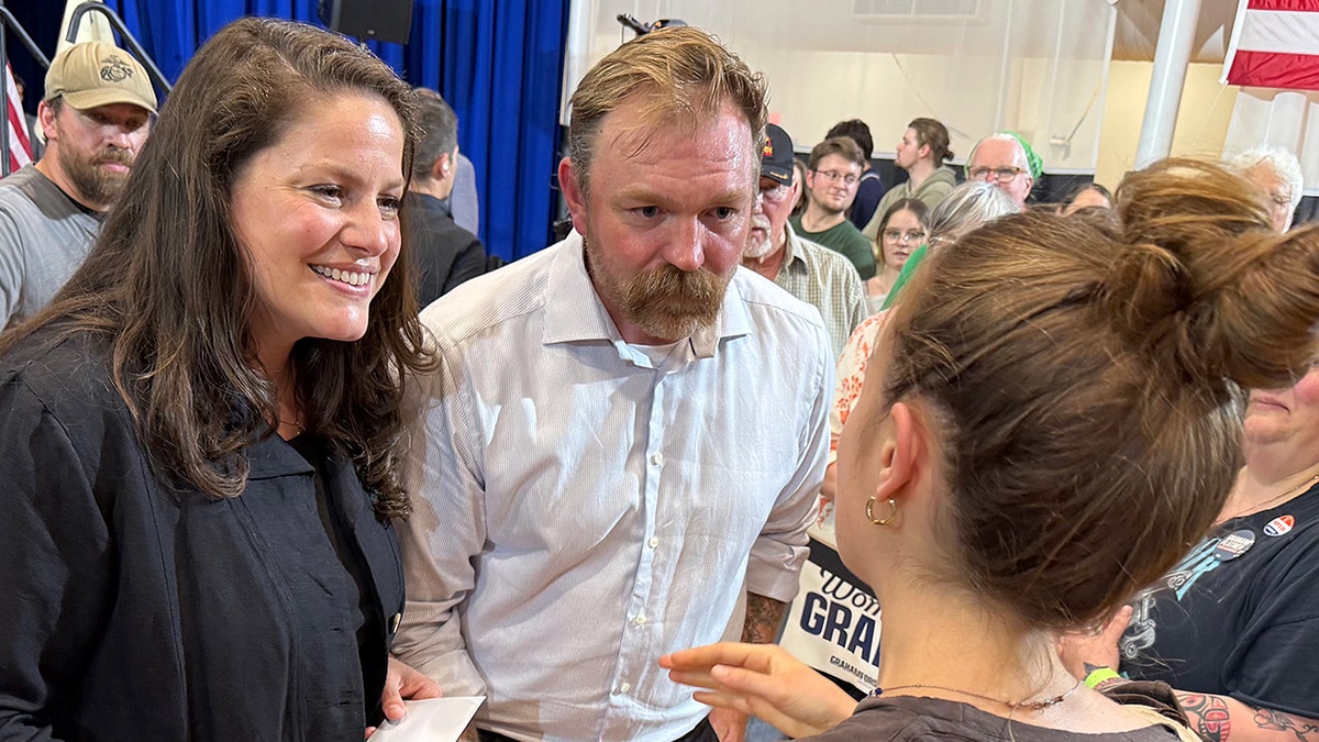 Graham Platner and wife talking to supporters