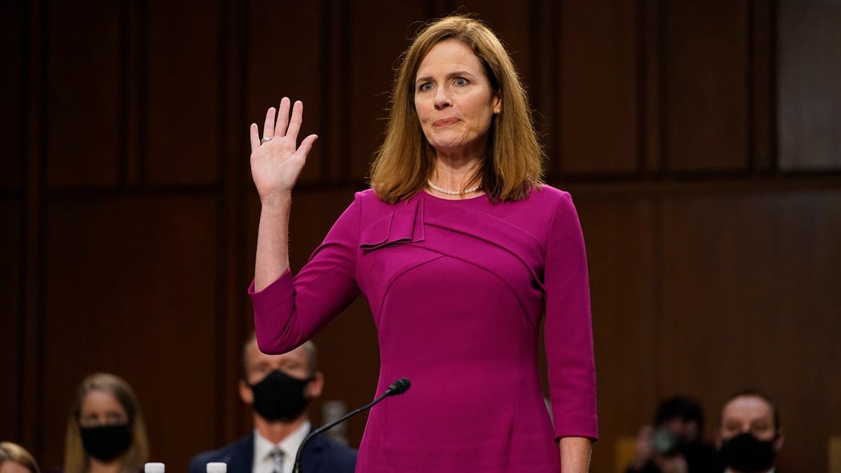 Supreme Court nominee Amy Coney Barrett raising her right hand during Senate Judiciary Committee hearing