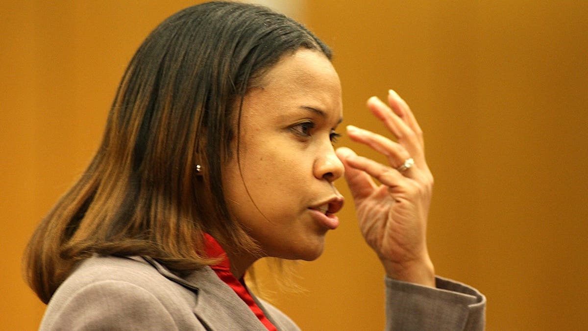 judge eleanor ross brushes her hair out of her face during testimony