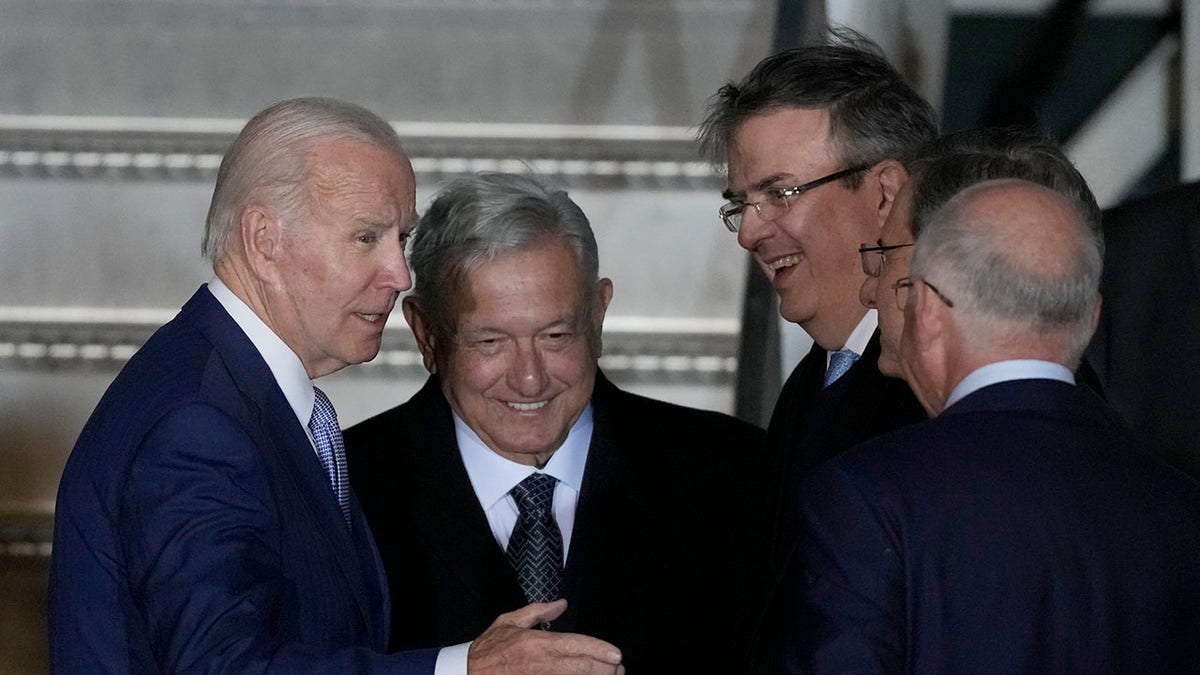 U.S. President Joe Biden is greeted by Mexican President Andres Manuel Lopez Obrador and others at Felipe Angeles international airport.