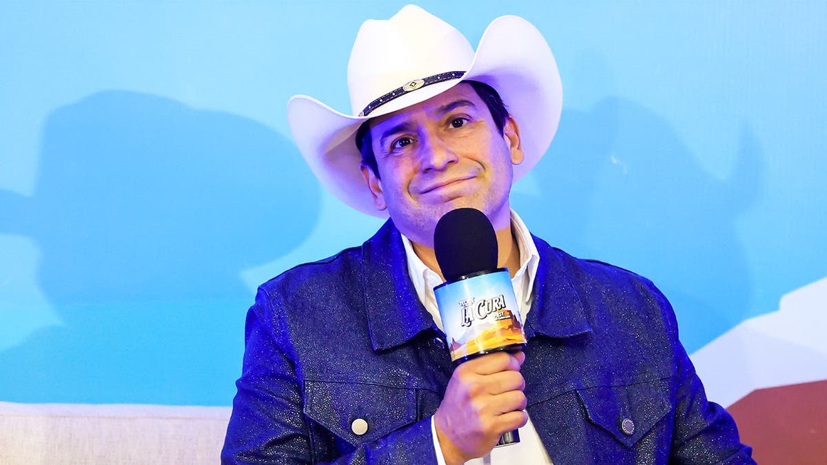 Bobby Pulido holding a micrphone