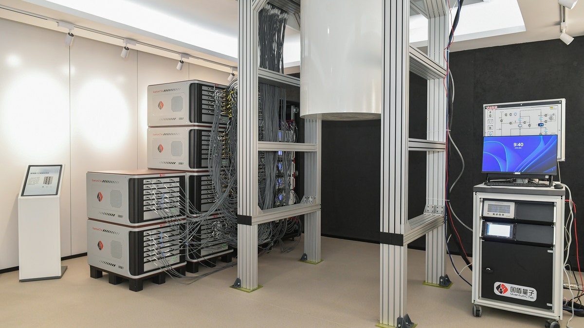 An operating superconducting quantum computer chip inside a white metal tank at QuantumCtek Co LTD in Hefei