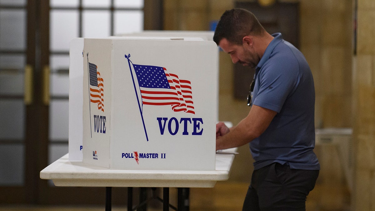 A voter filling out a mail-in ballot at the Board of Elections office in Pittsburgh, Pennsylvania