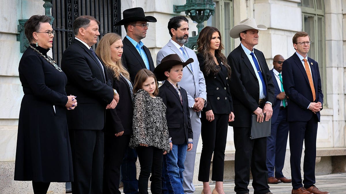 Larry Rhoden, Kristi Noem, Dusty Johnson, Marion Michael Rounds and a family outside court.