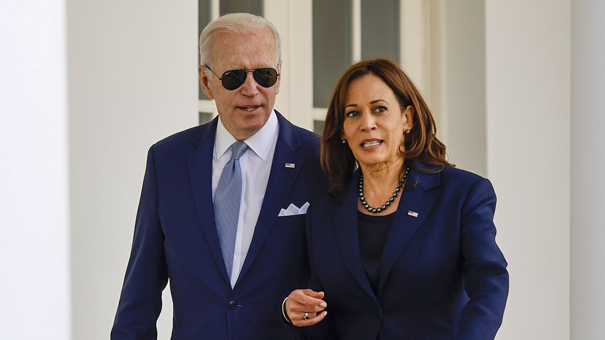 Former Vice President Kamala Harris walking and talking with President Joe Biden through the White House Colonnade