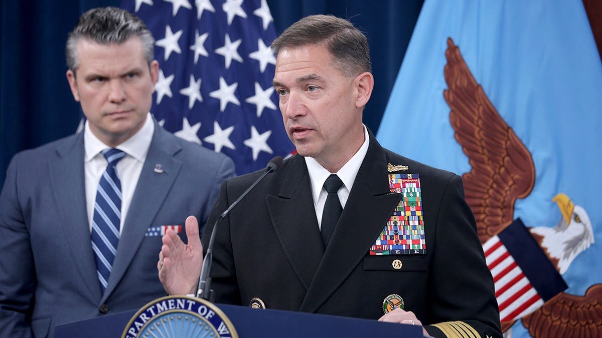 CENTCOM Commander Adm. Brad Cooper speaks as War Secretary Pete Hegseth looks in the background