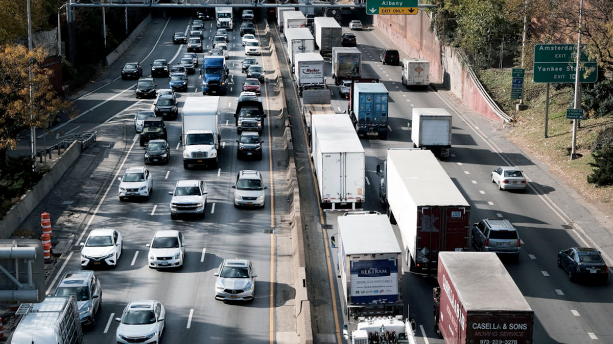 Truck traffic heading south on the Cross Bronx Expressway toward the Trans-Manhattan Expressway