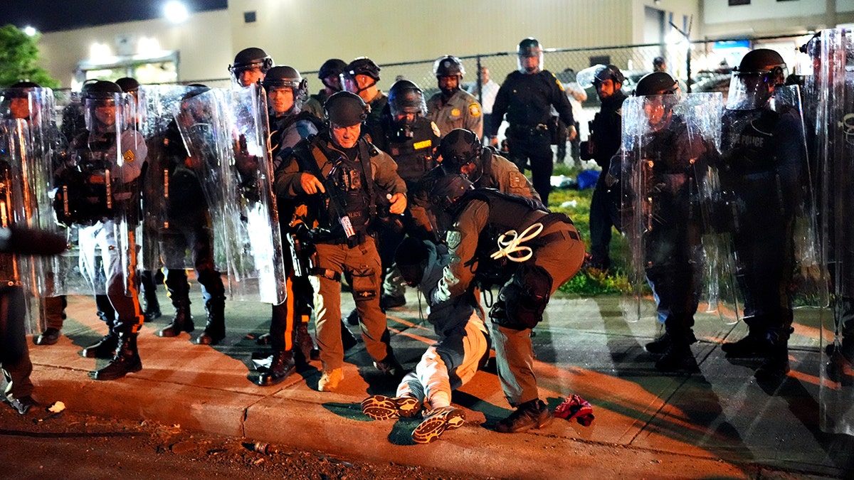New Jersey state police detaining a man outside Delaney Hall detention center