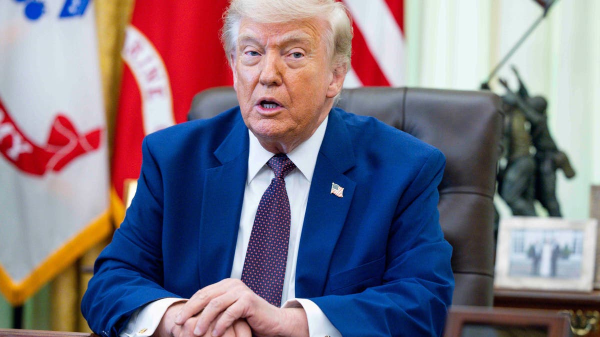 President Donald Trump signing an executive order in the Oval Office of the White House