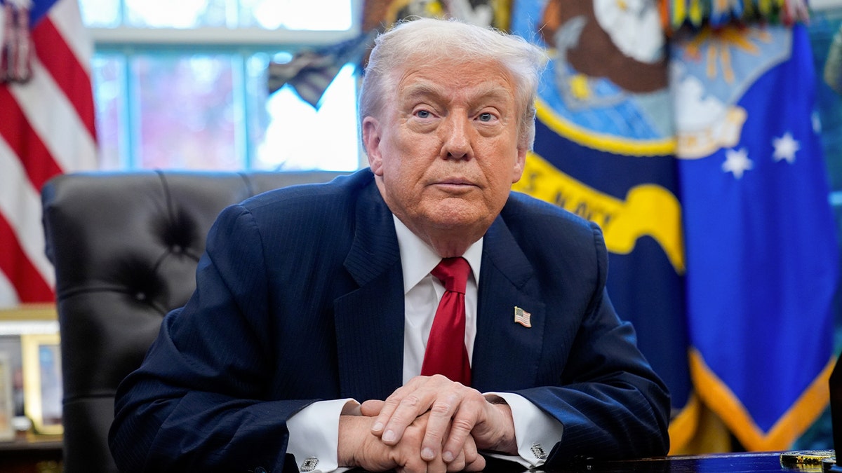 President Donald Trump sitting at the Resolute desk in the Oval Office.