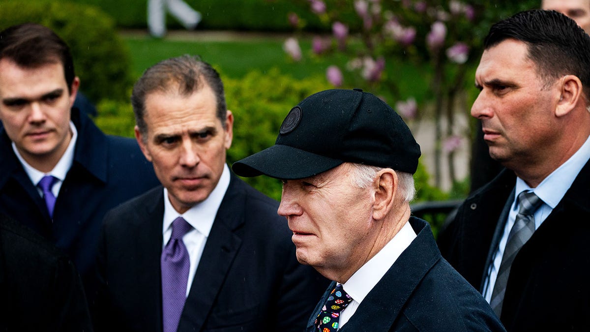President Joe Biden and his son Hunter Biden standing on the South Lawn of the White House