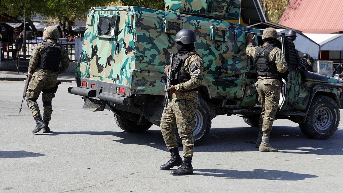 Members of the General Security Unit setting up a security perimeter in downtown Port-au-Prince