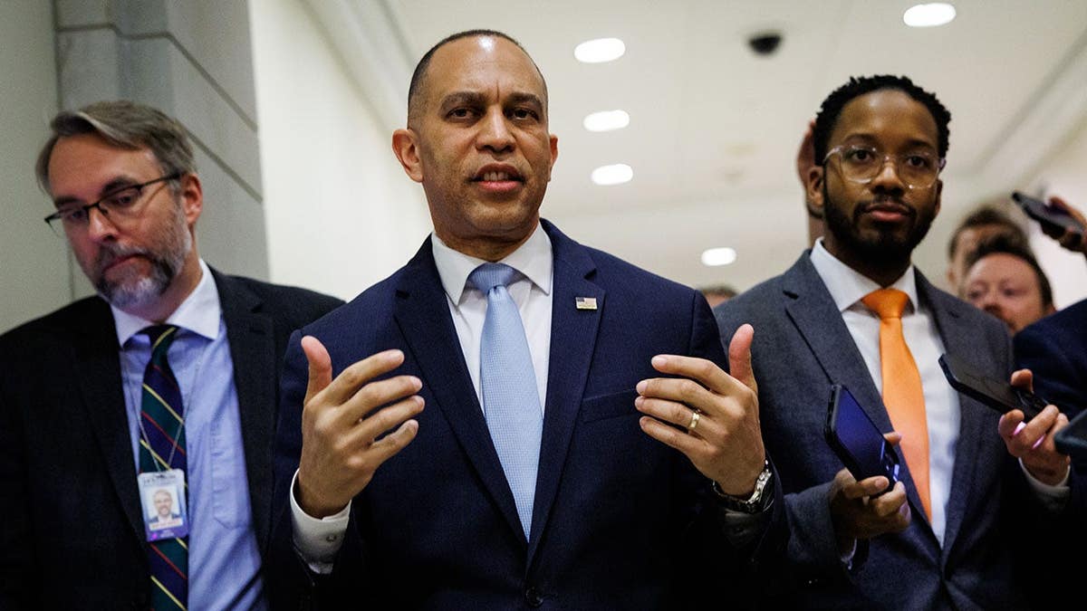U.S. House Minority Leader Hakeem Jeffries walking and speaking with reporters at the U.S. Capitol