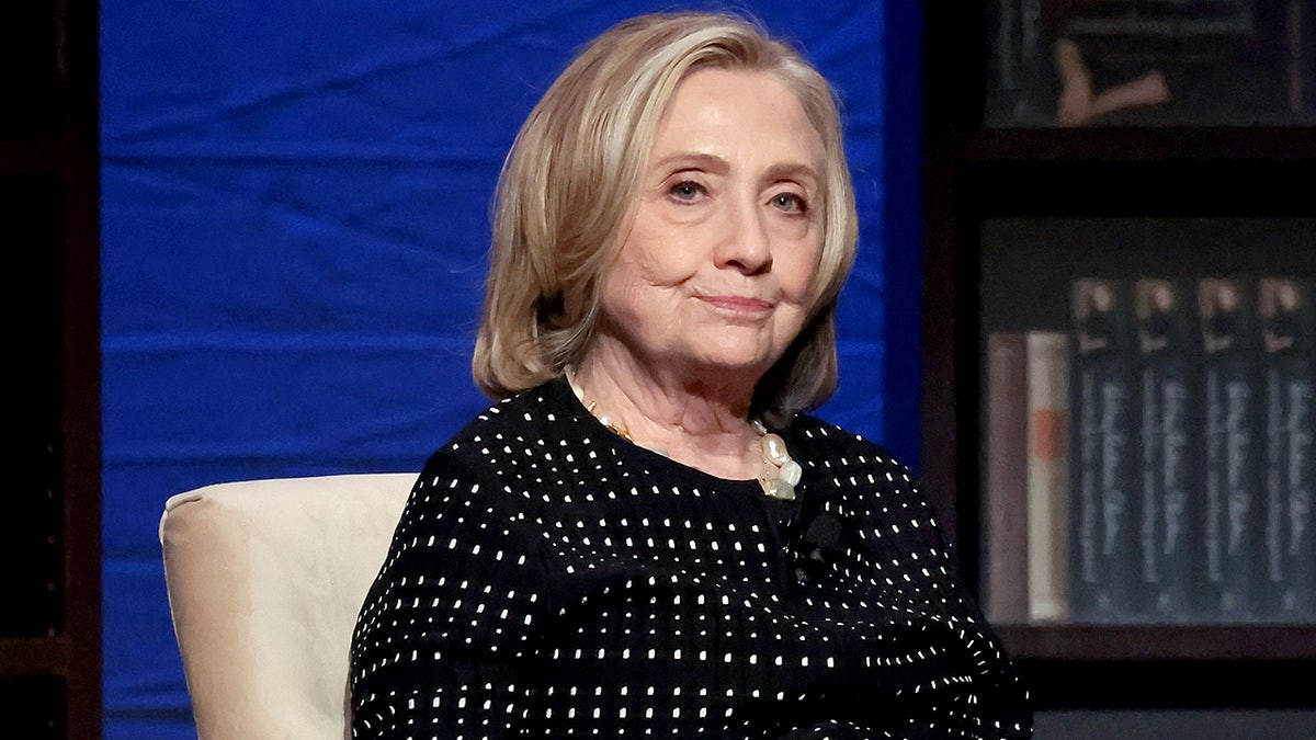 Hillary Rodham Clinton speaking onstage at a podium during a book release event