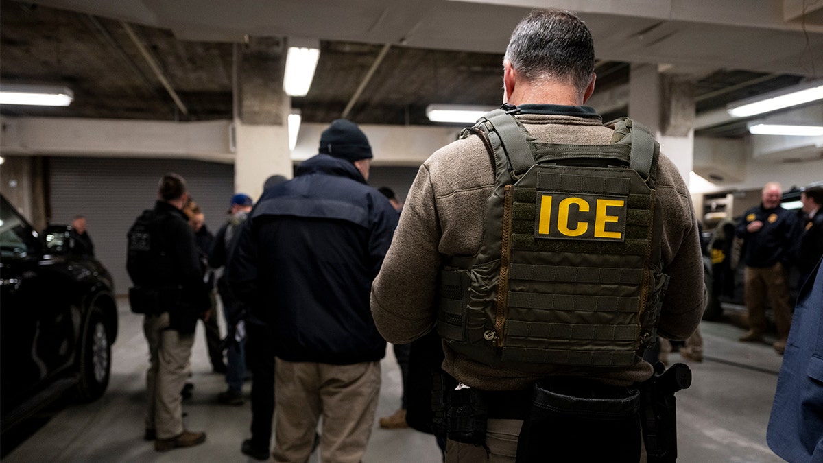 ICE agents and federal law enforcement officers attending a meeting in a garage