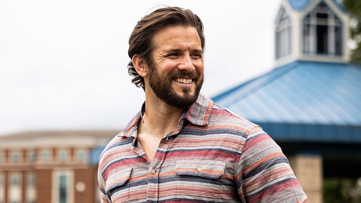 Former Navy SEAL Jared Hudson standing and smiling
