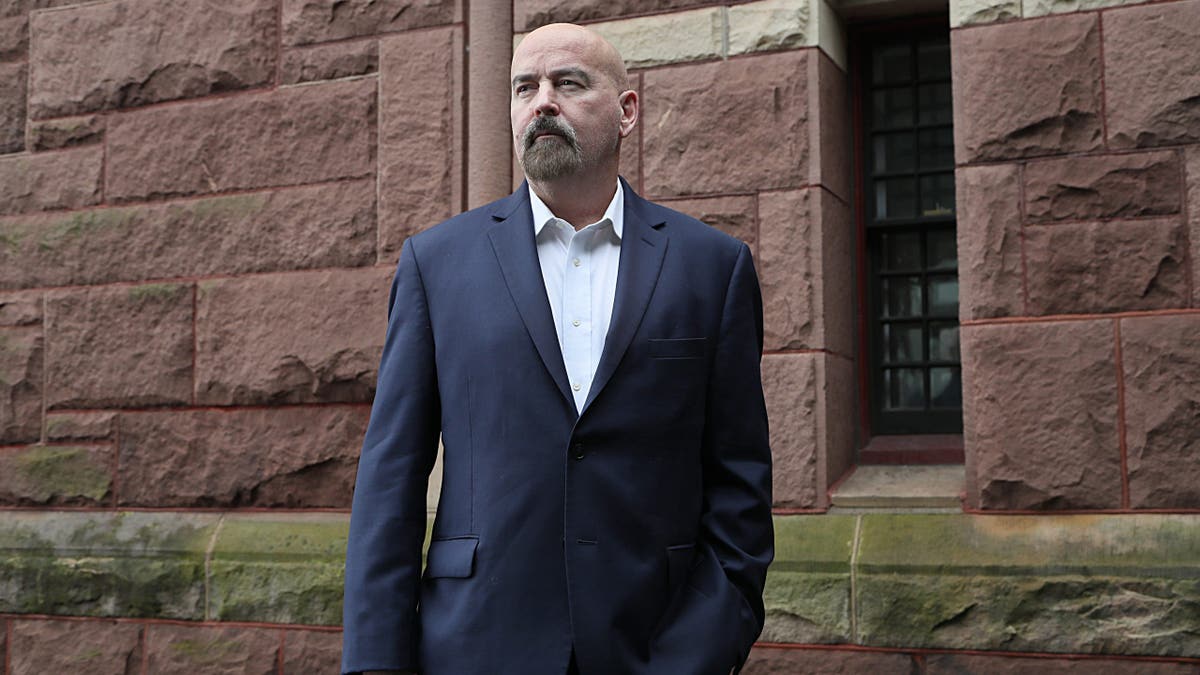 John Deaton posing for a portrait in Woburn, Massachusetts.
