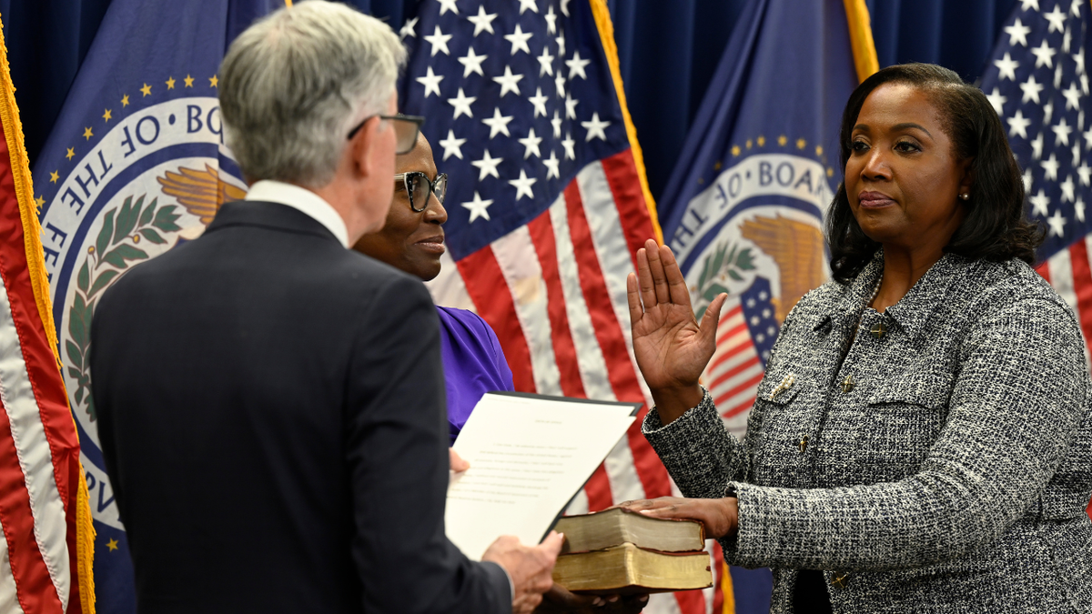 Federal Reserve Chairman Jerome Powell swearing in Lisa D. Cook at a ceremony.