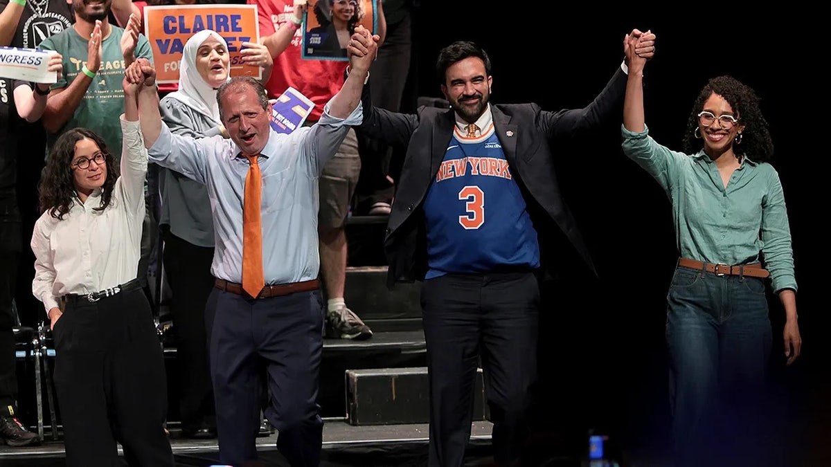 Congressional candidate Claire Valdez, Brad Lander, Mayor Zohran Mamdani, and Darializa Avila Chevalier raising hands at a rally