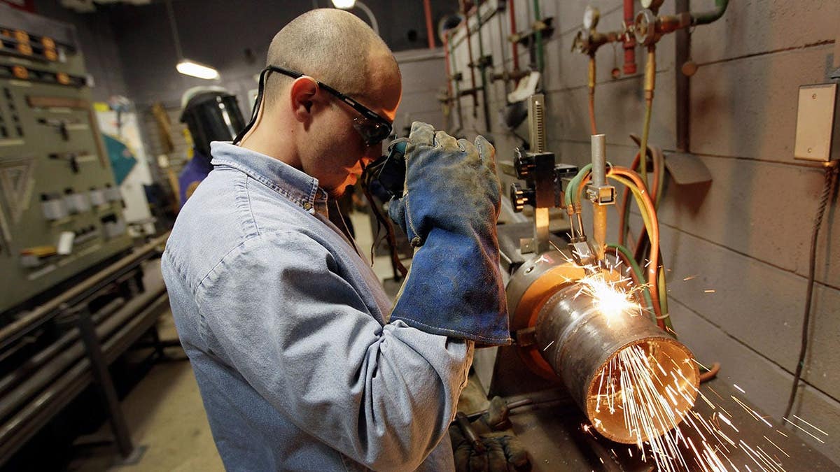 Michael Paz uses a torch to cut a pipe at the Air Conditioning Refrigeration and Pipefitting Education Center in Opa Locka Florida
