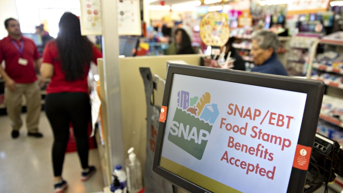 Screen displaying SNAP EBT food stamp benefits inside Family Dollar store in Chicago