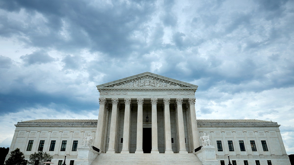 United States Supreme Court building under rain clouds in Washington, D.C.