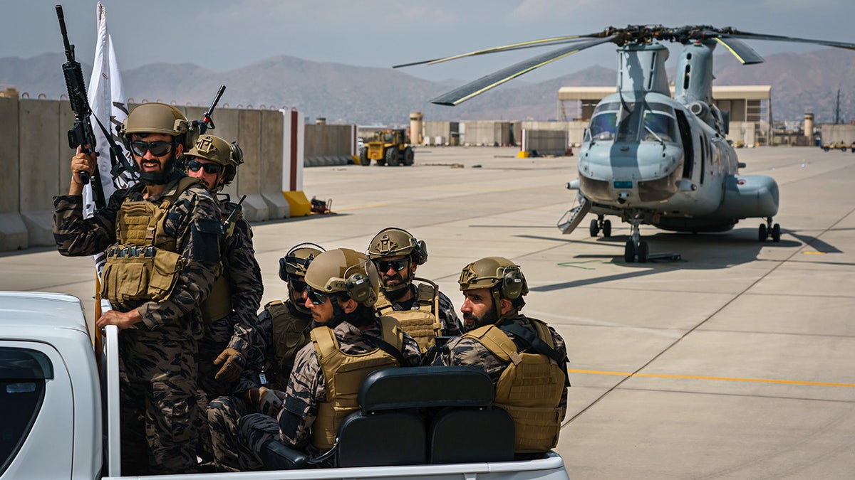Taliban fighters riding in a vehicle at Hamid Karzai International Airport in Kabul