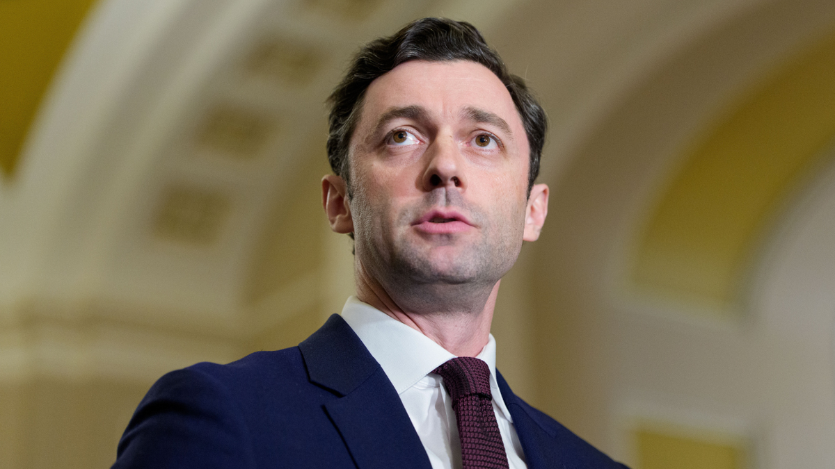Democrat Senator Jon Ossoff listens to a news conference at the U.S. Capitol.