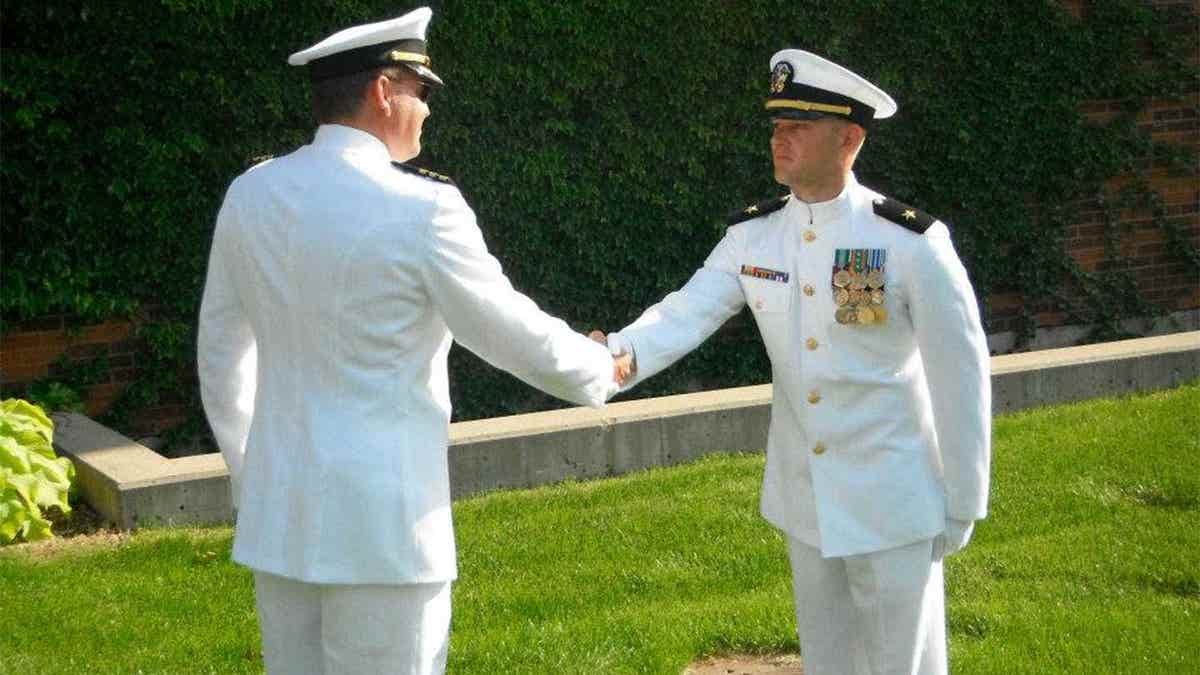 Adam Schwarze in Navy uniform shaking hands