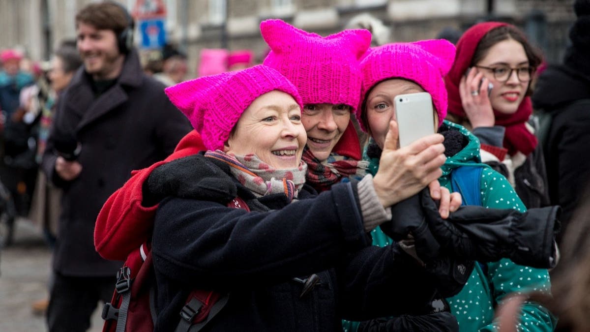Women, wearing the so-called Pussy Hat, pose for a selfie during a rally to mark the International Women's Day in Copenhagen, Denmark on March 8, 2017.
