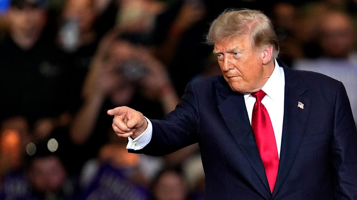 President Donald Trump gestures while speaking at the General Motors Proving Ground in Milford, Mich.