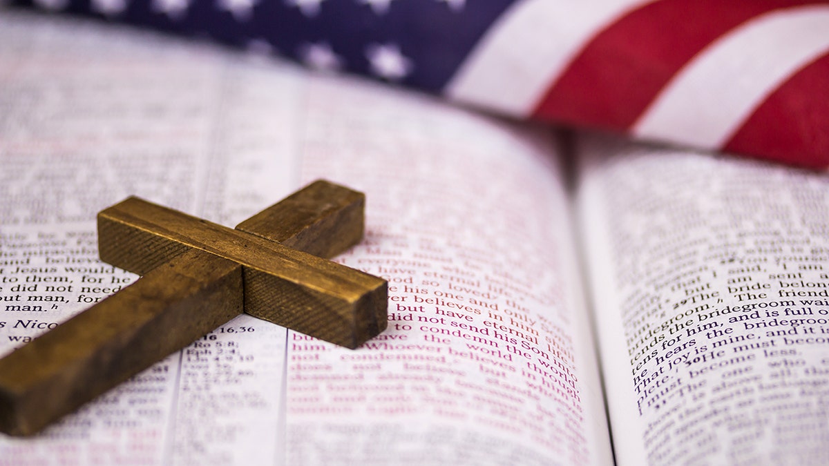 The Bible with the American flag and cross on top.
