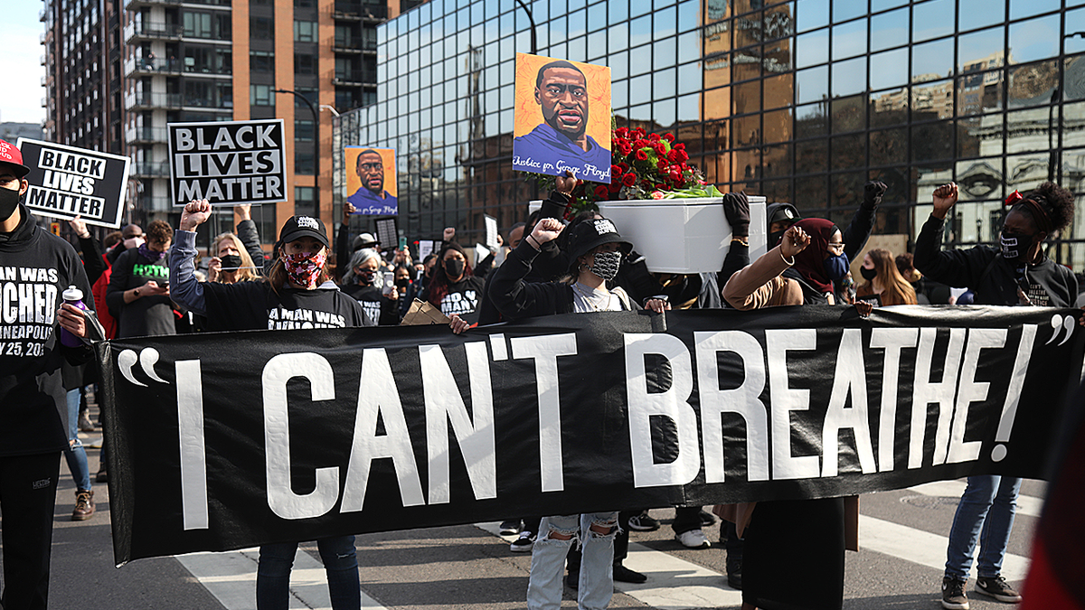 Demonstrators carrying a banner during a silent march in Minneapolis Minnesota