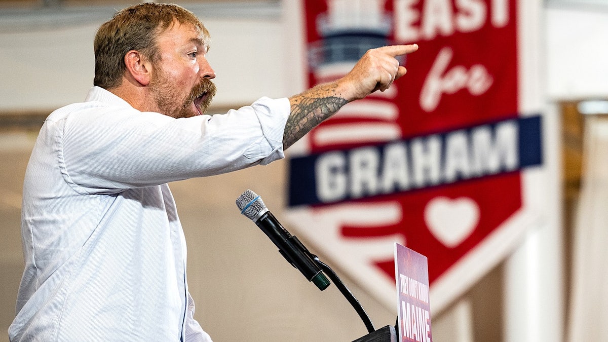 graham platner exults and points during a primary victory speech