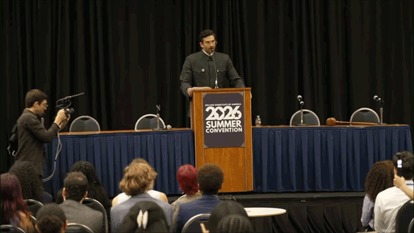 Hasan Piker in front of a podium