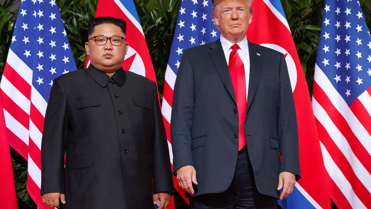 President Donald Trump poses with North Korean leader Kim Jong Un