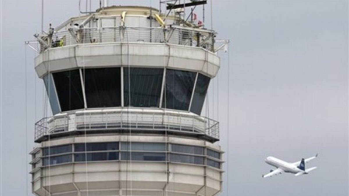 A passenger jet flies past the FAA control tower at Washington's Ronald Reagan National Airport, Thursday, March 24, 2011.