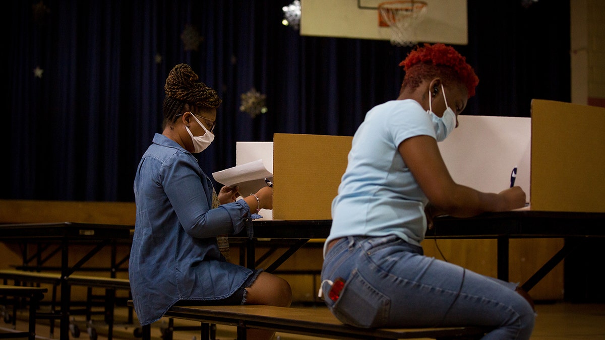 Voters cast ballots at a polling location in Newark, New Jersey, U.S., on Tuesday, July 7, 2020. The primaries Tuesday feature party-switching Representative Jeff Van Drew seeking re-election as a Republican and will set the matchups in three other districts Democrats captured from Republicans in 2018. Photographer: Michael Nagle/Bloomberg via Getty Images