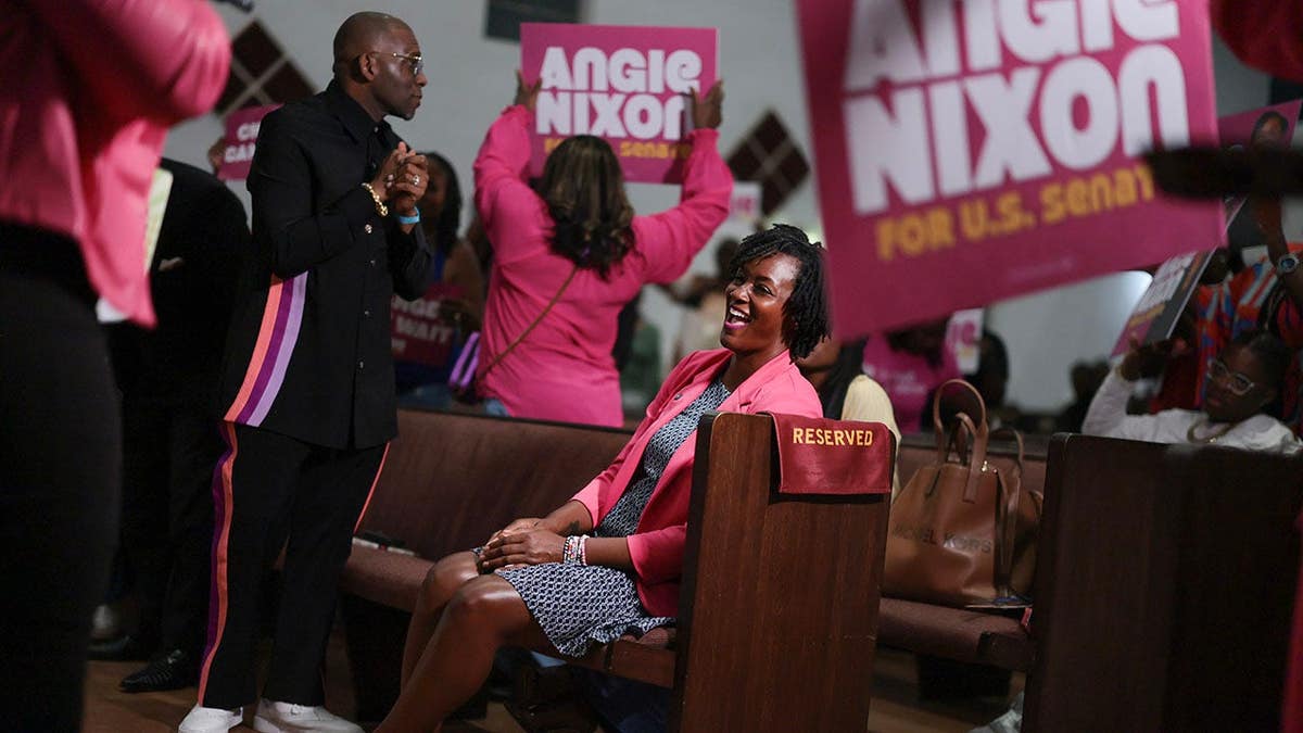Angie Nixon participates in a worship service at Ebenezer Missionary Baptist Church.