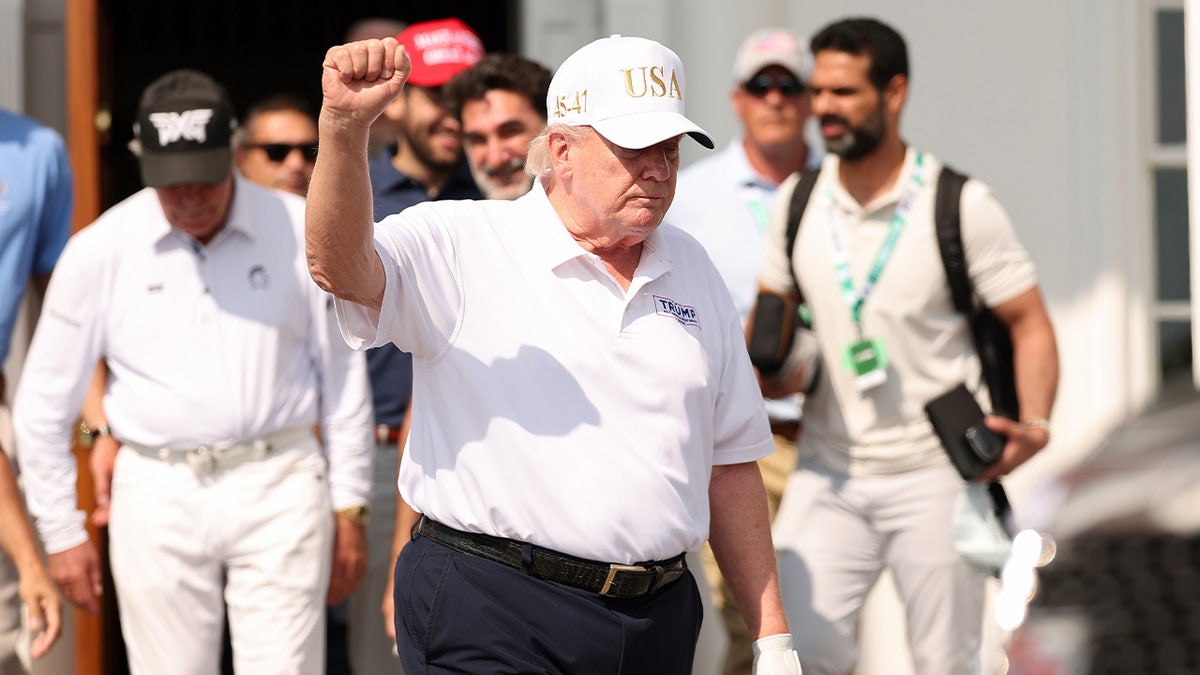 President Donald Trump holds his fist in the air