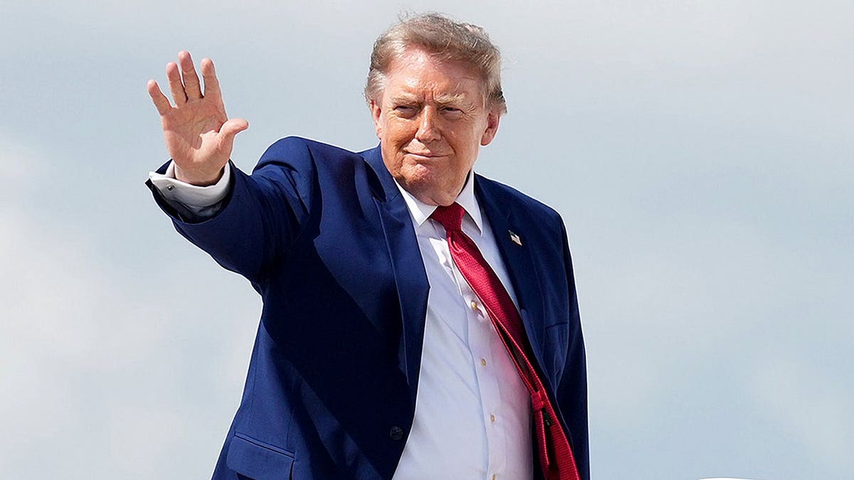 Donald Trump waves as he boards Air Force One at Joint Base Andrews.
