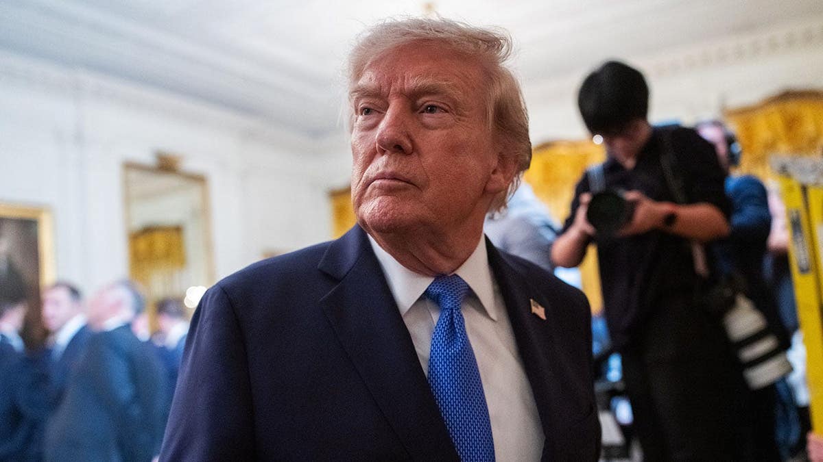 Donald Trump departs the White House East Room after hosting Team USA Olympians.