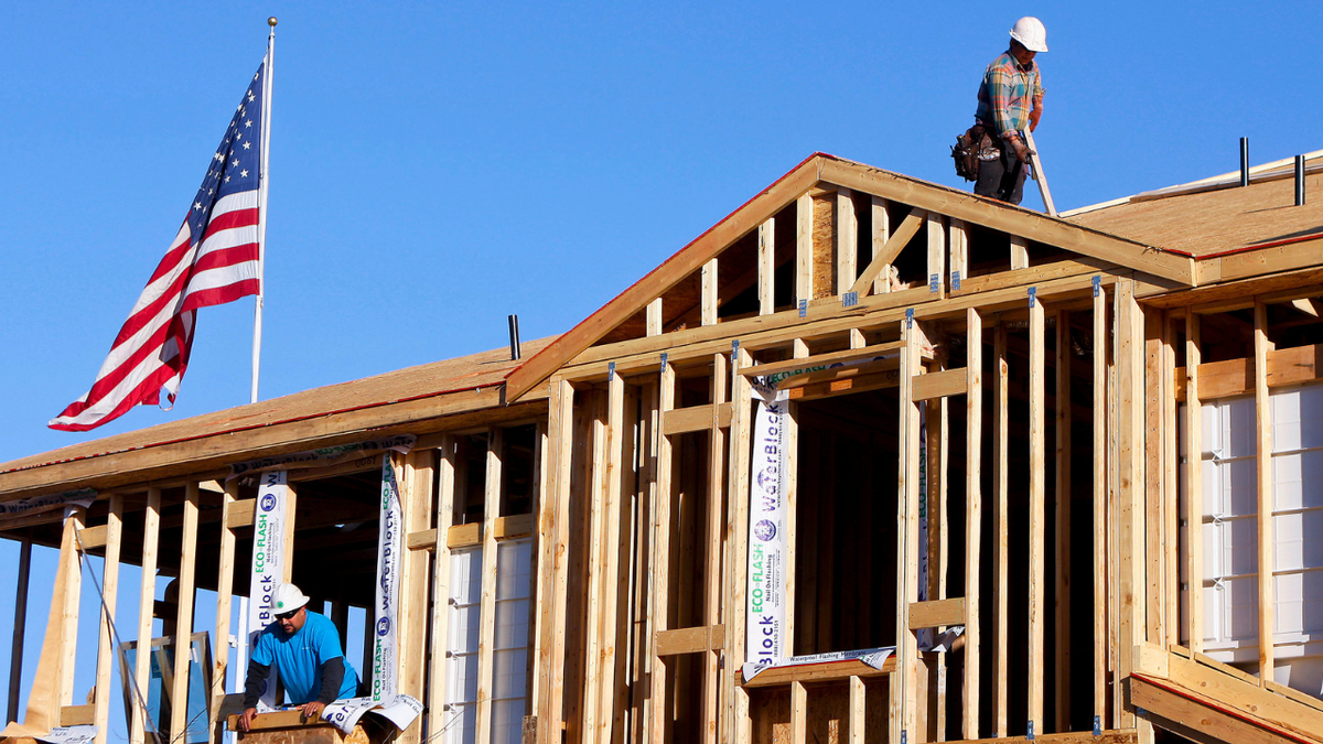 Construction workers are seen working on a new home in Phoenix, Arizona.