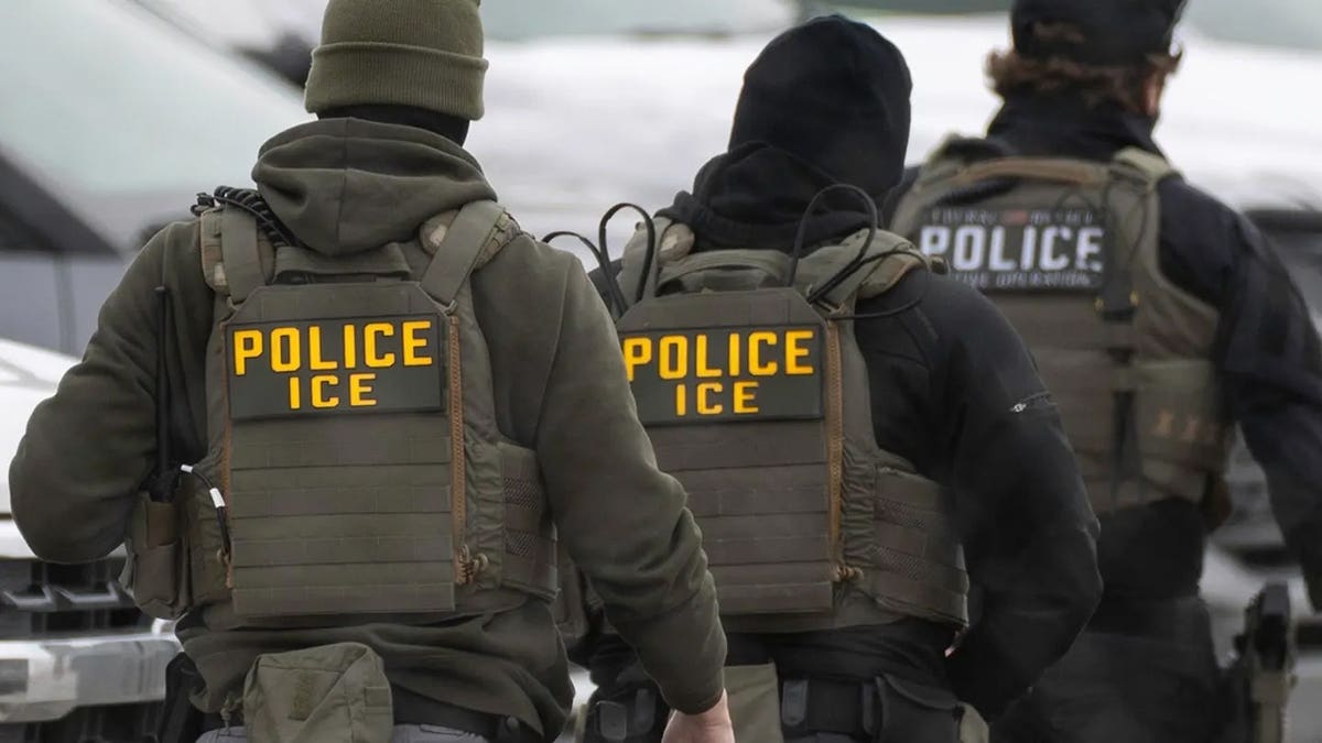 ICE agent walks in uniform