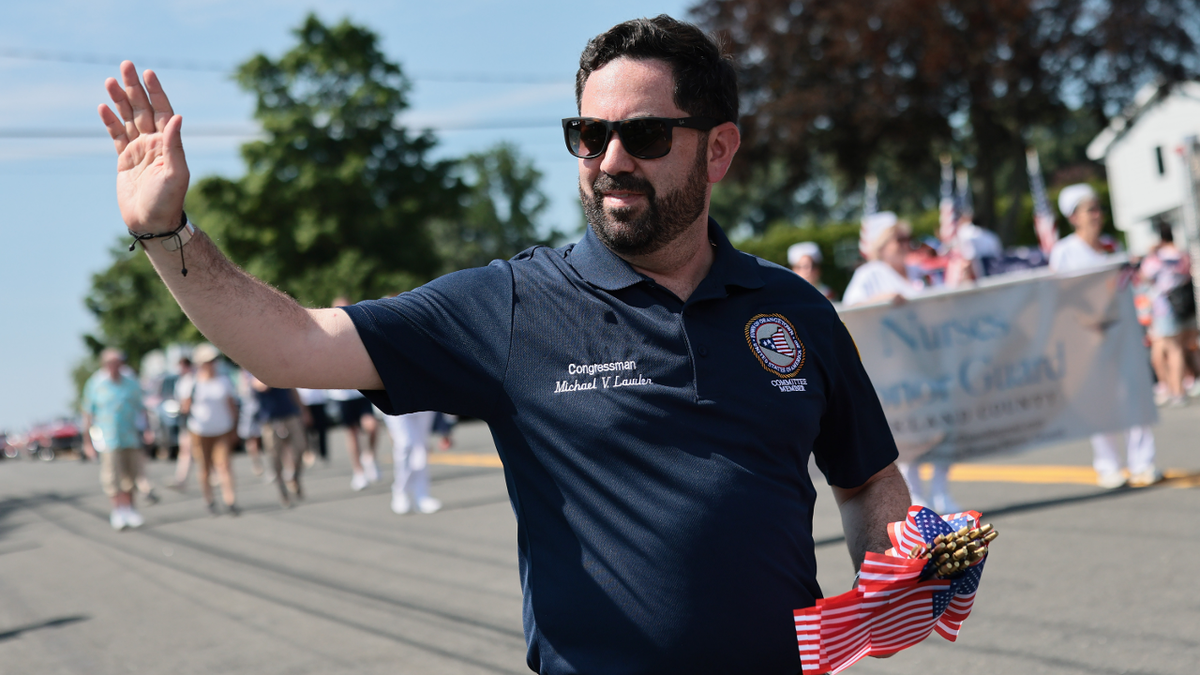 Rep. Mike Lawler, R-N.Y., marches in a July Fourth Parade