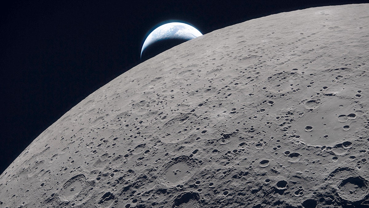 Earth setting behind the lunar horizon as seen from space.