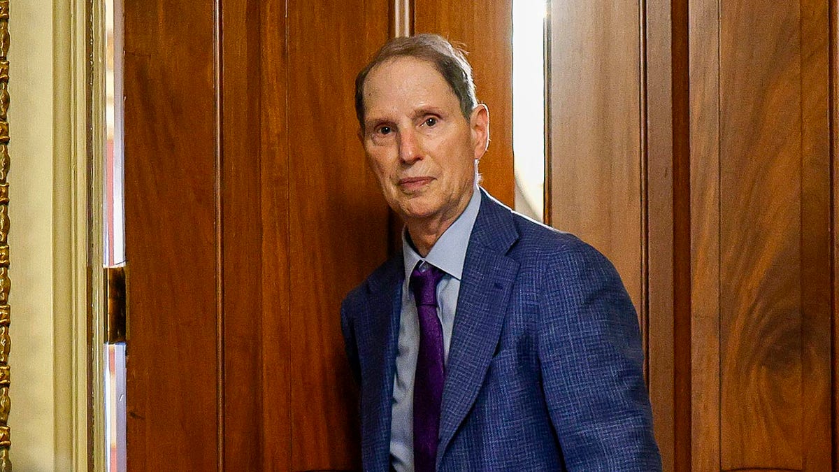 Ron Wyden looks on