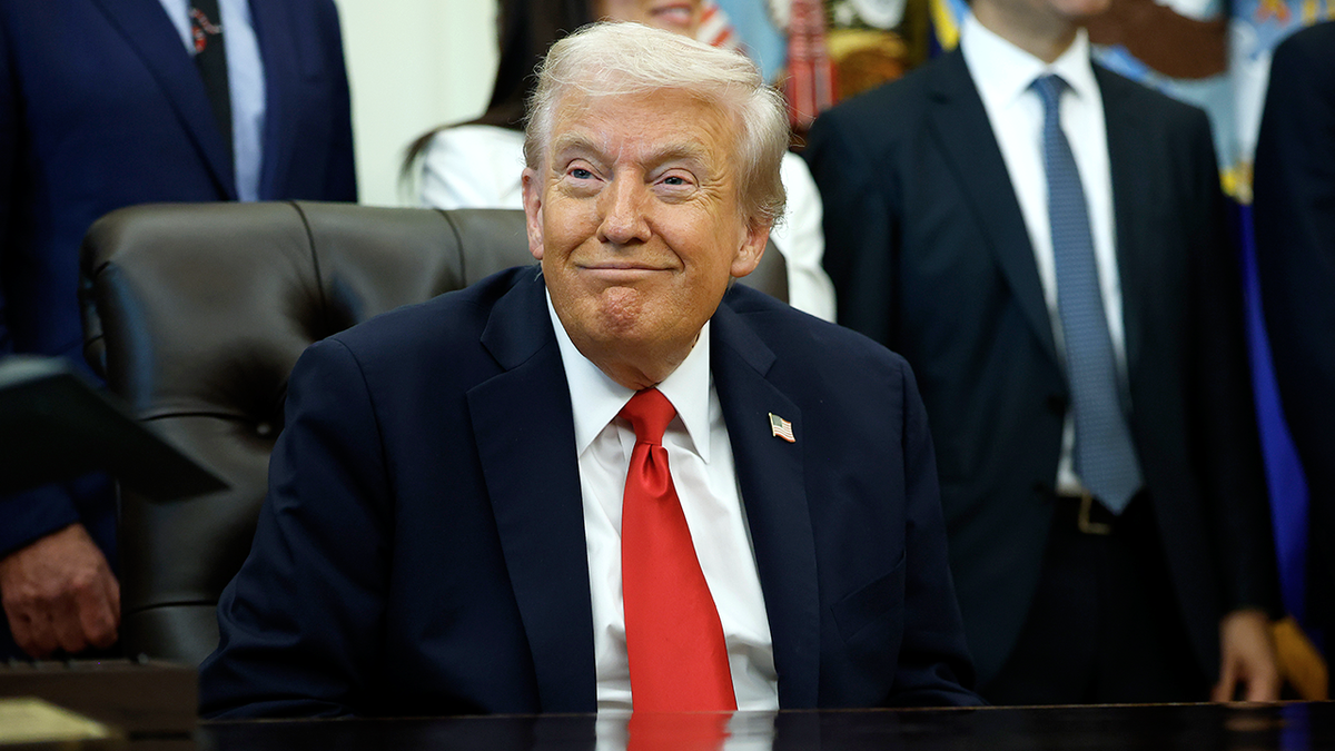President Donald Trump listens during Oval Office event on IVF access.