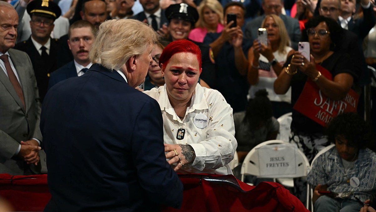President Donald Trump greets the parents of Jacob Freytes at the Nassau County Police Academy Center for Training and Intelligence in Garden City, New York, on August 14, 2026.