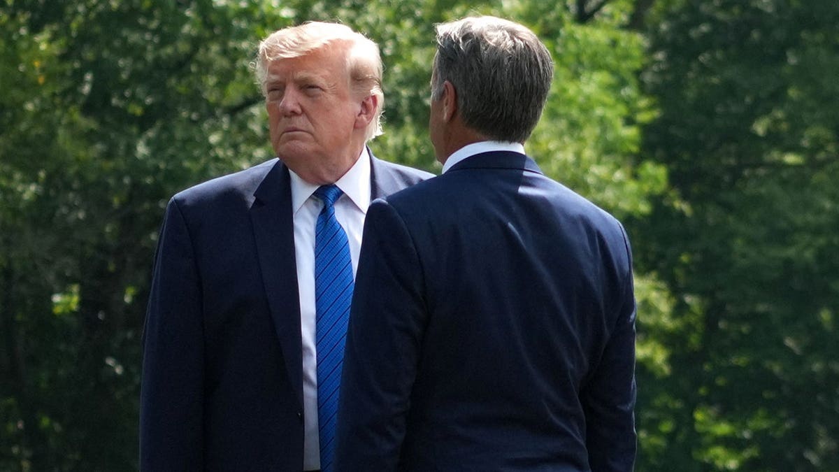President Donald Trump and John Ratcliffe speak together as they depart a Cabinet meeting.